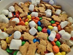 a bowl filled with marshmallows, pretzels, and puppy chow