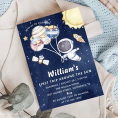 an astronaut themed birthday party is set up on a bed with blue sheets and pillows