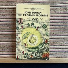 the pilgrim's progress by john bunyann on a shelf in a library