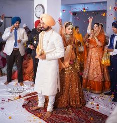 the bride and groom are throwing confetti at each other