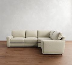 a white couch sitting on top of a wooden floor