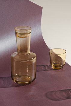 two glasses sitting on top of a table next to each other