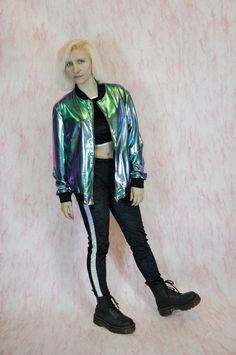 UNISEX OIL SLICK  HOLOGRAPHIC BOMBER JACKET, THIS BOMBER JACKET HAS BEEN LOVINGLY HANDMADE IN OUR LONDON STUDIO.  UNISEX CUT  FABRIC IS STRETCHY  BLACK CUFFS AND NECK  OIL SLICK HOLOGRAPHIC FABRIC GRAB ONE NOW, AS ALL OUR ITEMS ARE HANDMADE IN VERY LIMITED RUNS. ---------------------------------------------------------------------------------------------------------------  SIZE CHART   ------------------------- SIZE SMALL: CHEST, INCHES 36-38  SIZE MEDIUM: CHEST, INCHES 40-42  SIZE LARGE: CHEST, Rave Mermaid, Mermaid Oil, Young Outfit, Cyberpunk Outfit, Clothes Grunge, Holographic Fabric, Goth Rave, Festival Clothes, Wishlist 2024