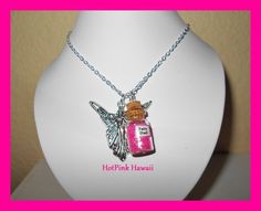 a necklace with a bottle on it and a winged charm