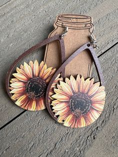 a pair of sunflower earrings with leather straps