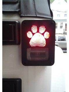 a traffic light with a dog paw on it's red light and black leather case