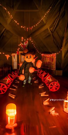 a large teddy bear sitting on top of a wooden table next to candles and signs