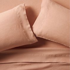 the sheets and pillow cases have been made with linens in pale pink colors,