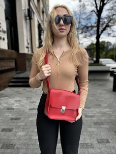 This personalized leather shoulder bag is a stylish and practical choice for everyday use. Crafted in a striking red, this crossbody women's bag combines functionality with minimalist design. It's perfect for carrying daily essentials while adding a pop of color to any outfit. As a unique gift for your sister or a special woman in your life, this bag is both thoughtful and personal. Its high-quality leather and customizable options make it a standout piece that she'll cherish for years to come. Modern Red Crossbody Flap Bag, Modern Red Satchel Flap Bag, Modern Red Flap Bag For Daily Use, Everyday Red Flap Bag With Adjustable Strap, Minimalist Flap Bag With Adjustable Strap, Red Crossbody Flap Bag For Office, Trendy Flap Bag As A Gift, Trendy Flap Bag Gift, Trendy Flap Bag As Gift