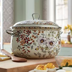 an ornately decorated casserole sits on a counter next to other dishes and utensils