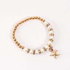 Add a touch of cute to your outfit with the Selah Pearl Bracelet. Featuring a timeless gold stretch bracelet with genuine freshwater pearls and sweet gold seashell or starfish charm, this bracelet brings a bit of fun to any summer outfit. Stretch style bracelet Nickel Free Hypoallergenic Beach Inspired Bracelets, White Pearl Bracelet With Charm For Beach, Gold Beaded Charm Bracelet For Beach, Gold Pearl Charm Bracelet For Beach, Adjustable Gold Charm Bracelet With Starfish Charm, Gold Seashell Bracelet, Gold Stretch Bracelet, Seashell Bracelet, Gold Beach