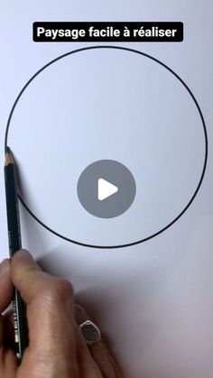 someone is drawing a circle with a pencil