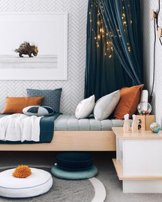 a bedroom with a bed, rugs and pictures on the wall above it is decorated with lights