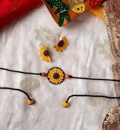 the sunflowers have been placed on the table with beads and bead work