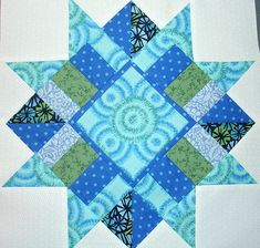 a blue and green quilted star on a table