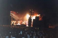 a group of people standing on top of a stage in front of a large crowd