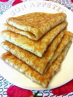 there are four pancakes on the plate and one has been cut in half to make it look like they're ready to eat