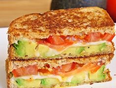 an image of a grilled sandwich on a plate with the caption, avocado mozzarella and tomato grilled cheese