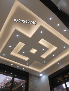 the ceiling is decorated with white lights and black trimmings, along with an open window