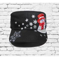 a black hat with a santa clause on it and snowflakes around the brim