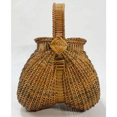 an old woven basket sitting on top of a table