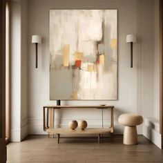 an abstract painting hangs on the wall above a console table