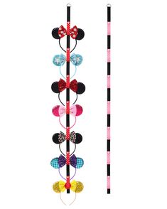 a pair of minnie mouse headbands on top of a pole next to a stick