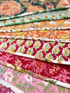 a close up of many different colored fabrics