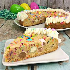 a cake with white frosting and sprinkles sitting on top of a plate