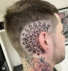 a man with a flower tattoo on his head