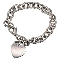 A fine Tiffany & Co. sterling silver bracelet. With slightly oval links and a heart-shaped pendant charm. The charm is not engraved. Great Tiffany design! Date: 20th Century Overall Condition: It is in overall good, as-pictured, used estate condition with some very fine & light surface scratches and other signs of expected light wear consistent with age. Fineness: Marked 925 for sterling silver fineness. Marks: Tiffany & Co. / 925 Measurements: Length: ca. 7 1/4 in. (or ca. 190 mm) Width: ca. 10 Tiffany And Co Bracelet, Dog Chain, Starfish Bracelet, Silver Dog, Tiffany Jewelry, Elsa Peretti, Metal Chain Link, Tiffany And Co, Sterling Silver Bracelet