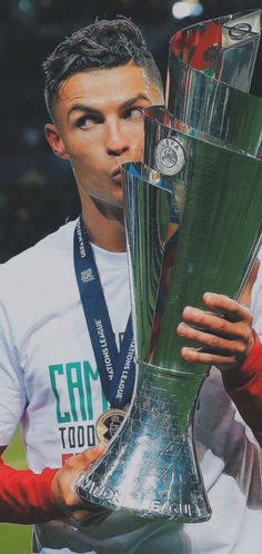 a man holding a silver trophy in his right hand