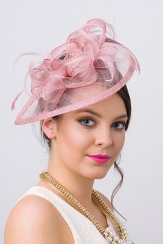 Timeless glamour. This sassy fascinator gives a nod to vintage style with a bouncy mesh ribbon and flighty feathers. With its classic sinamay mesh shape and elegant look it will be your go-to fascinator for the season. - Light weight - Attached to headband for easy wear - Comes in 18 bold colors Classy Hats, Pink Fascinator, Pretty Hats, Sinamay Hats, Red Hat Society, Hat Fascinator, Ladies Hats, Hats And Fascinators, Kentucky Derby Hats