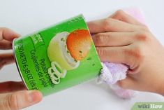 a person holding a can of ice cream with an orange on it's wrapper