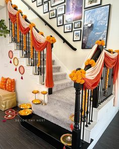 the stairs are decorated with orange and white flowers on them, along with other decorations