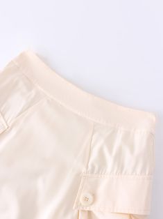 The Button Cargo Pocket Skirt in Ivory offers both style and functionality. Its neutral color makes it easy to pair with any outfit. A must-have addition to your wardrobe. Chic Cream Lined Skirt Bottoms, Beige Mini Skirt With Button Closure, Cream Lined Mini Skirt For Work, Chic Beige Skirt With Button Closure, Chic Beige Mini Skirt With Pockets, Cream Knee-length Bottoms For Summer, Cream Lined Skirt Bottoms For Work, Cream Lined Skirt For Workwear, Cream Lined Skirt For Work