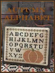 an old fashioned cross stitch pattern with the words autumn alphabet and a pumpkin on it