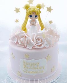 a birthday cake with a doll on top and stars around the edges that say happy birthday, queenie