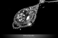 Adela Vintage Art Deco Clear Diamond 27 Carat Oval Pendant Necklace. Description: This gorgeous 27 Carat Vintage Art Deco Pendant Style is created with best quality 16 Carat Clear Oval Cut Crystal Center Stone, Accented by Clear Pave Cubic Zirconia and 18.5 Inch plus Extender Link Chain and Polished into a Lustrous Silvertone Finish. This is a vintage timeless piece will pair beautifully with your event attire. All Cubic Zirconia shines a lot like diamond. This is a Great Travel Piece, which giv Deco 27, Event Attire, Oval Pendant Necklace, Victorian Pendants, Celebrity Jewelry, Wedding Pendant, Art Deco Pendant, Cubic Zirconia Jewelry, Cz Pendant