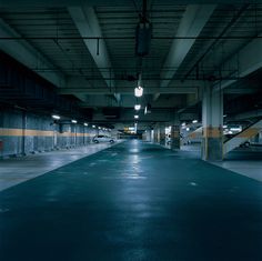 an empty parking garage filled with lots of lights and no one in the car park