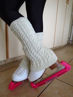 a person in white socks riding on a pink scooter with black and white leg warmers