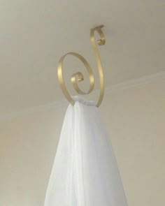 a white towel hanging from a hook on the ceiling