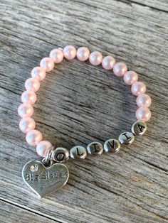 "Looking for a gift for the new big sister to be! This is the perfect gift from her new little baby sister or brother! What better way to announce someone is going to be a big sister? Give her this special personalized bracelet with her name on it! She will adore it for years to come. This makes a great gift to give her when introducing her to her newest sibling! I have one for the \"middle sister\" too! You can find that one here: https://www.etsy.com/listing/748914103/middle-sister-bracelet-pe New Big Sister Gifts, Pearl Name, Big Sister To Be, Big Sister Bracelet, New Big Sister, Sister Announcement, Big Sister Announcement, Middle Sister, Flower Girl Bracelets