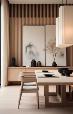 a dining room table with chairs and vases on it