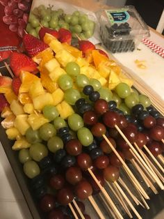 fruit skewers are arranged on sticks and ready to be eaten