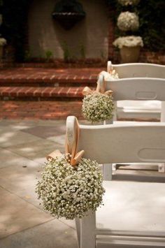 the chairs are decorated with baby's breath flowers