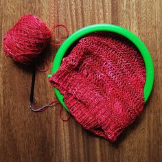 two balls of yarn sitting on top of a wooden table