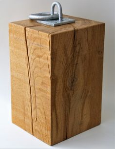 a wooden box with a metal latch on it's side and a white background