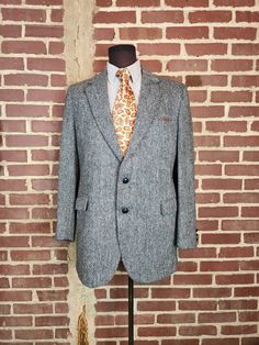 Fair vintage condition. Has one spot on left cuff that needs a repair, otherwise good condition. As is. Blue grey tweed Harris Tweed Textured wool Size 42L Fabric wool tweed Shoulders 19.5 Chest 44 CB length 32 Arm/Sleeve, cuff to shoulder seam 27 Gray Wool Tweed Jacket For Formal Occasions, Single Breasted Wool Tweed Jacket, Classic Tweed Sport Coat For Semi-formal Occasions, Vintage Tweed Suit For Formal Occasions, Vintage Tweed Jacket With Notch Lapel For Business Casual, Vintage Tweed Jacket For Business Casual With Notch Lapel, Semi-formal Wool Tweed Jacket, Vintage Tweed Sport Coat For Formal Wear, Vintage Tweed Blazer For Business