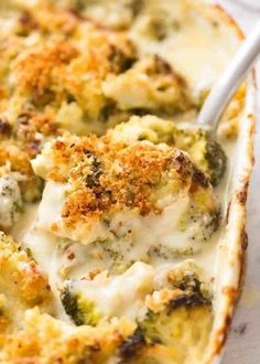 a casserole dish with broccoli covered in cheese and crumbs